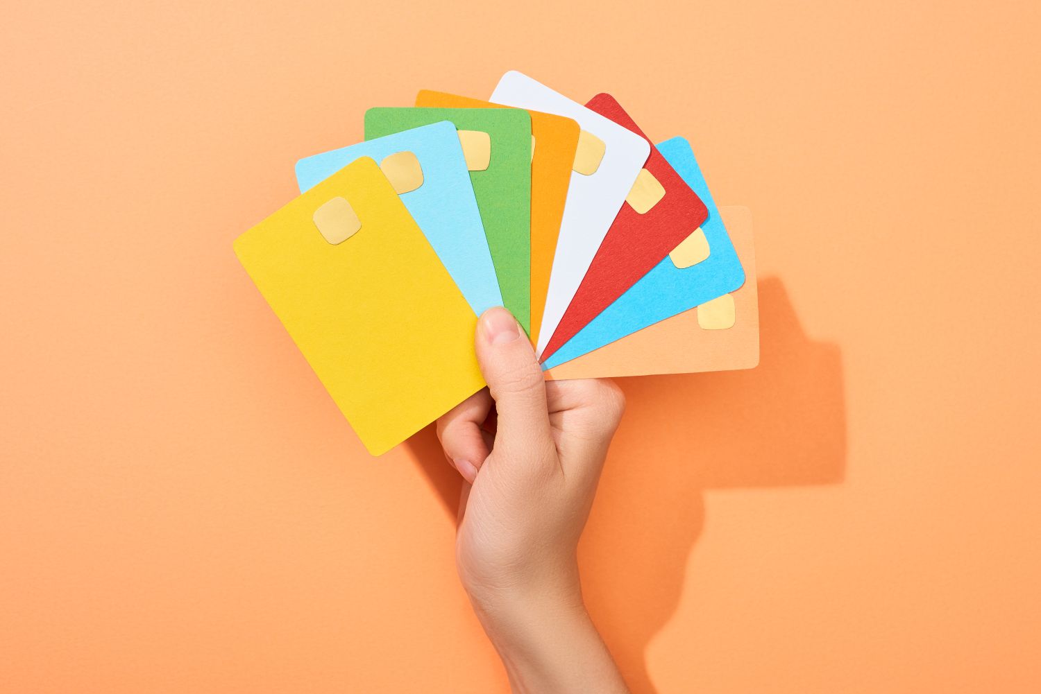 multicoloured cards held up
